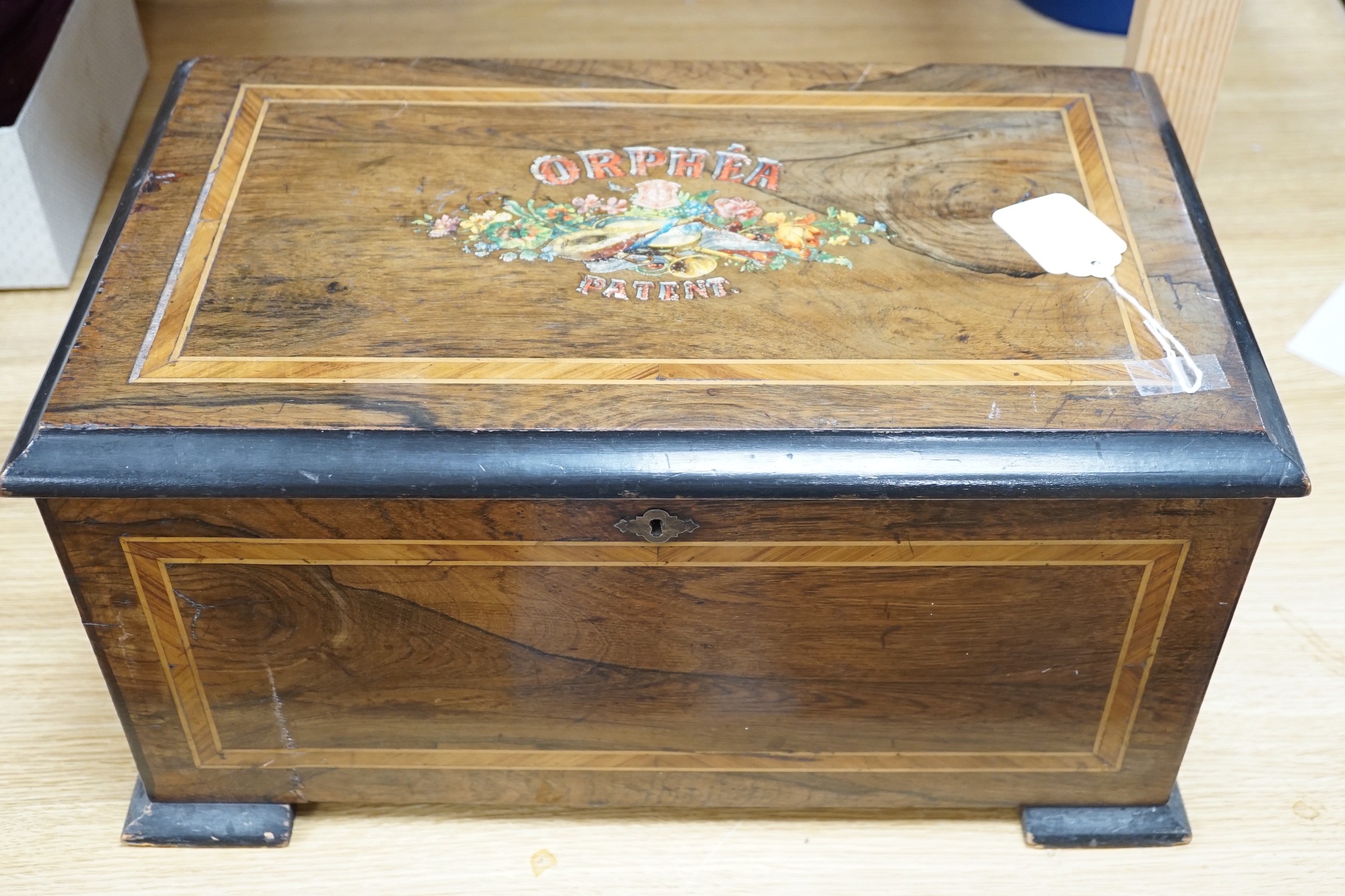 A Swiss Orphea patent rosewood and marquetry cased interchangeable cylinder music box, with four cylinders, also striking on three bells, each 14.5 cm cylinder playing for airs, 46 cms wide x 23 cms high